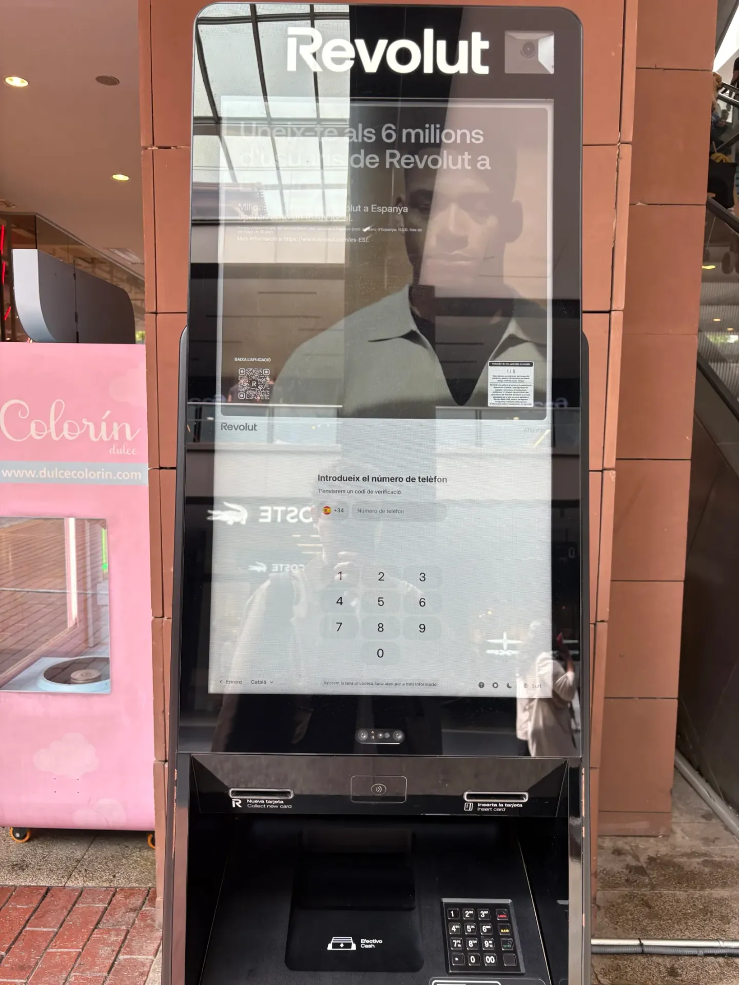 Revolut ATM displaying the Banking & Beyond idle attract screen in a shopping centre